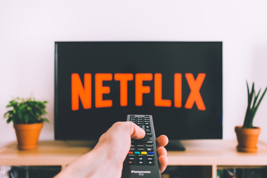 Person using remote control switching between streaming services on a smart TV